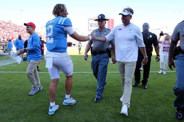 Nov 4, 2023; Oxford, Mississippi, USA; Mississippi Rebels quarterback Jaxson Dart (2) and Mississippi Rebels head coach Lane Kiffin (right) react after defeating the Texas A&M Aggies at Vaught-Hemingway Stadium. Mandatory Credit: Petre Thomas-USA TODAY Sports