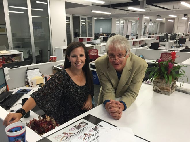 Sports columnists Jenni Carlson and Berry Tramel pose for a photo in The Oklahoman newsroom in 2016.