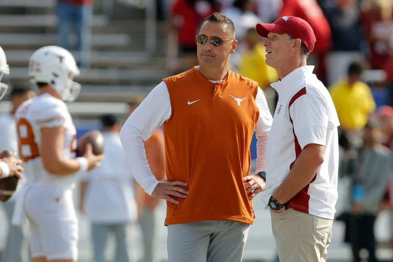 Oklahoma Sooners head coach Brent Venables, at right, and Texas Longhorns head coach Steve Sarkisian talk before the Red River Showdown college football game between the University of Oklahoma (OU) and Texas at the Cotton Bowl in Dallas, Saturday, Oct. 8, 2022. BRYAN TERRY/THE OKLAHOMAN / USA TODAY NETWORK
