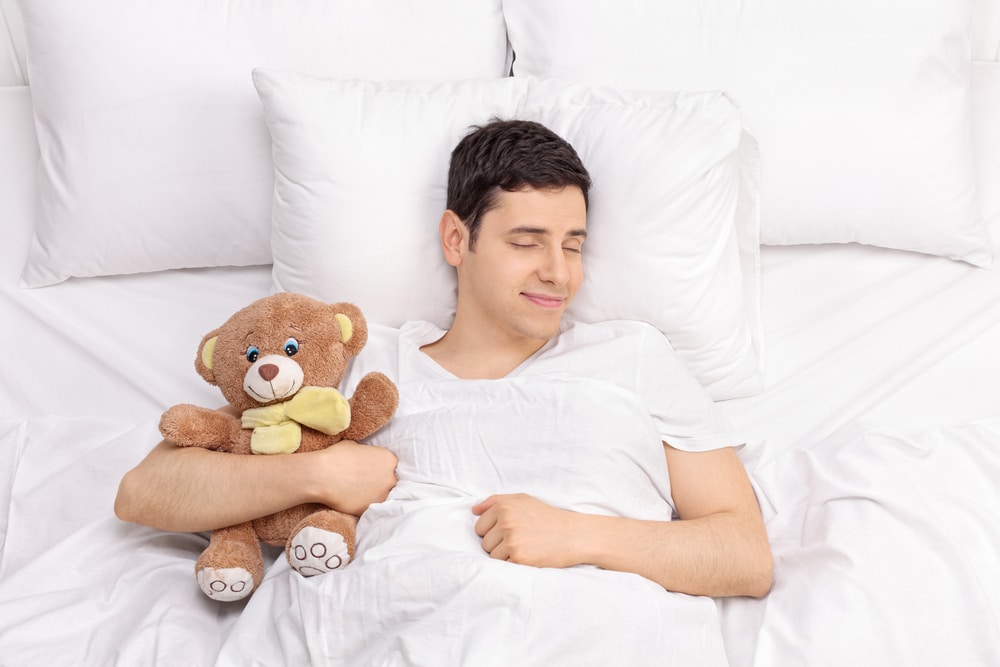 MoneyMagpie_Man-Bed-Sleeping-Tesing-Peaceful-Relaxed-Teddy-bear.jpg